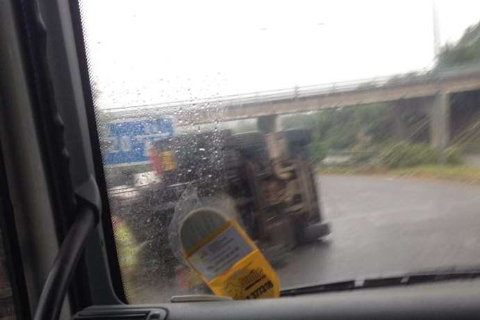 The overturned lorry on the slip road approaching the M20