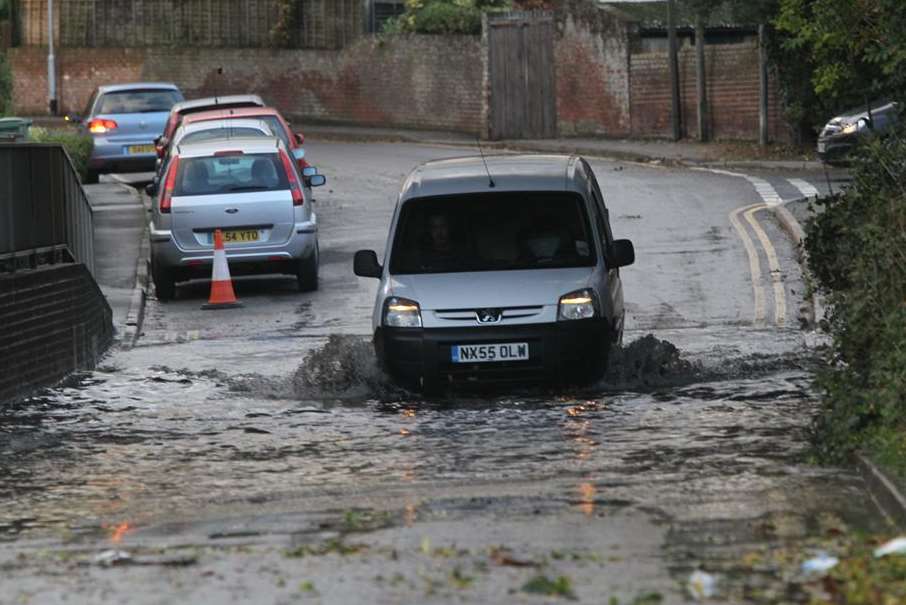 A van negotiates a flooded underpass in Pattenden Lane, Marden