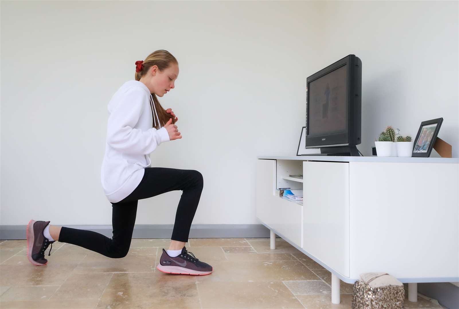 A girl from Derbyshire exercises at home (Scott Wilson/PA)