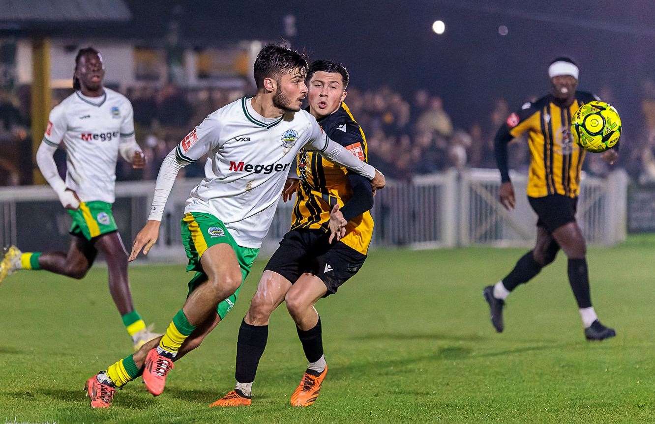 Dover's top scorer George Nikaj does his defensive duties, trying to get away from Folkestone left-back Frankie Morgan. Picture: Helen Cooper