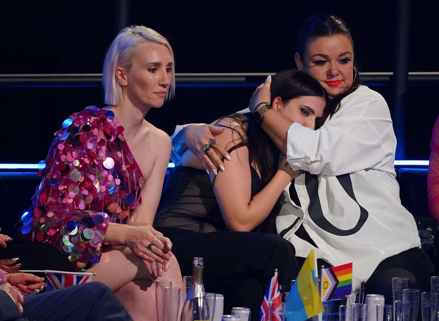 UK entrant Mae Muller (centre) reacts during voting in the Eurovision grand final. She ended in 25th place with 24 points (Peter Byrne/PA