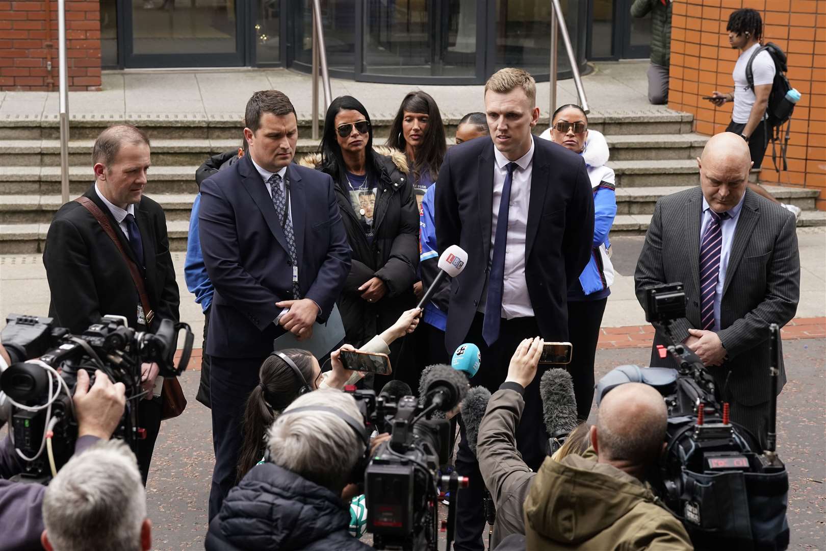 Detective Constable Lee Swift (second left) with Charlie Mclean, the mother of Khayri Mclean (centre left), and CPS prosecutor Dan Lee speaking to the media outside Leeds Crown Court (Danny Lawson/PA)