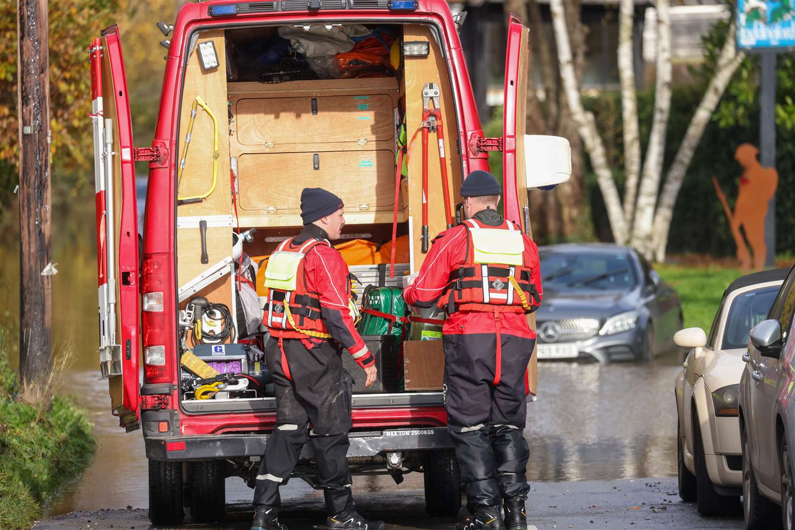 Fire crews helping the stranded car. Picture: UKNIP