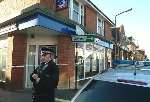 An armed police officer outside the building society