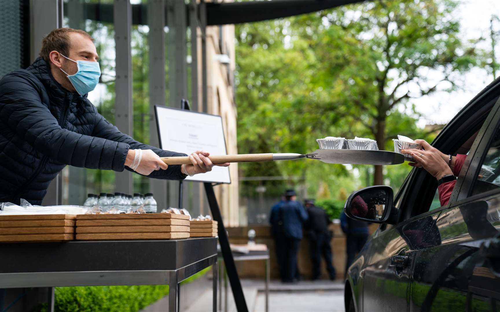 Food and drink is passed into a car, at a free drive-through for the emergency services at The Berkeley Hotel in Knightsbridge, London (Aaron Chown/PA Wire)