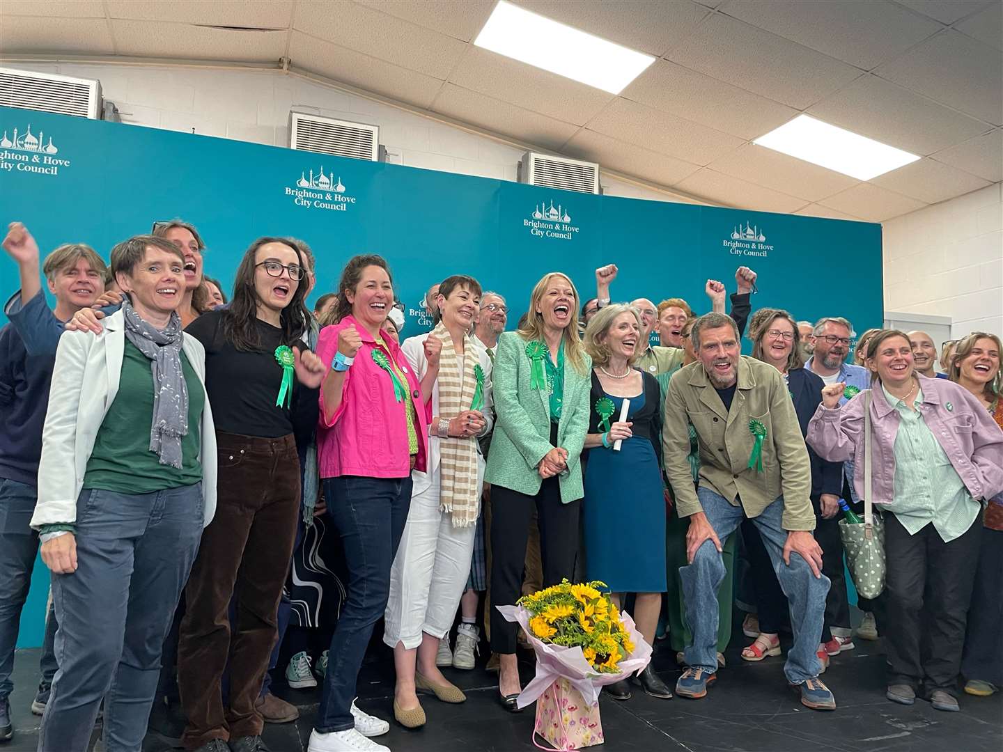 Sian Berry and Green Party supporters celebrate at the Portslade Sports Centre after winning the seat in the Brighton Pavilion constituency (Anahita Hossein-Pour/PA)