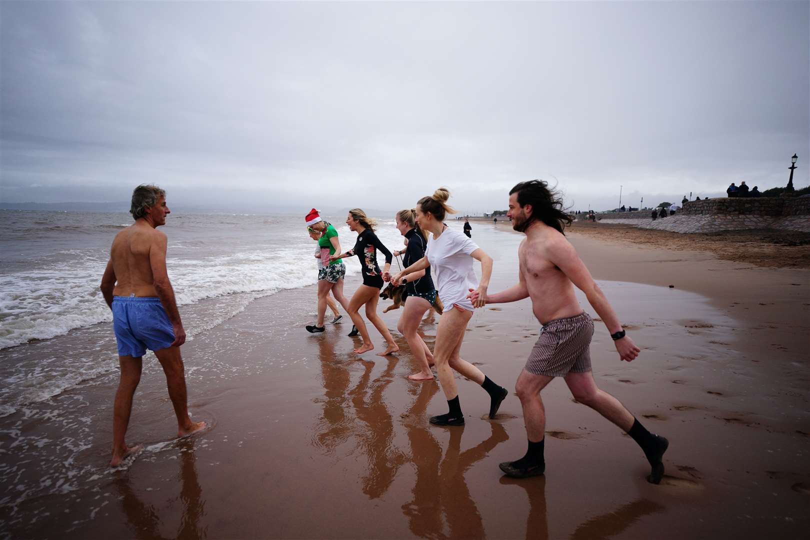 Swimmers take part in a Christmas Day dip at Exmouth, Devon (Ben Birchall/PA)