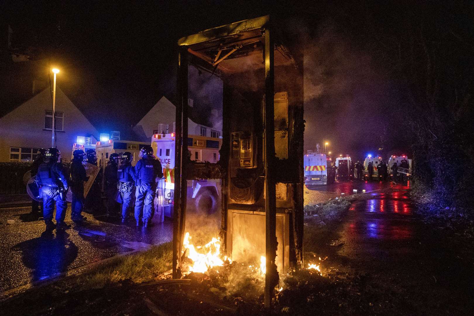 A phone box was set alight and surrounding roads were blocked with fires (Liam McBurney/PA)