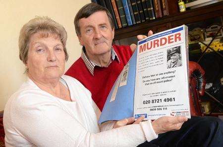Jean and Philip Bacon with their cuttings book about Philip's dad Geoffrey who was killed in a robbery in London.