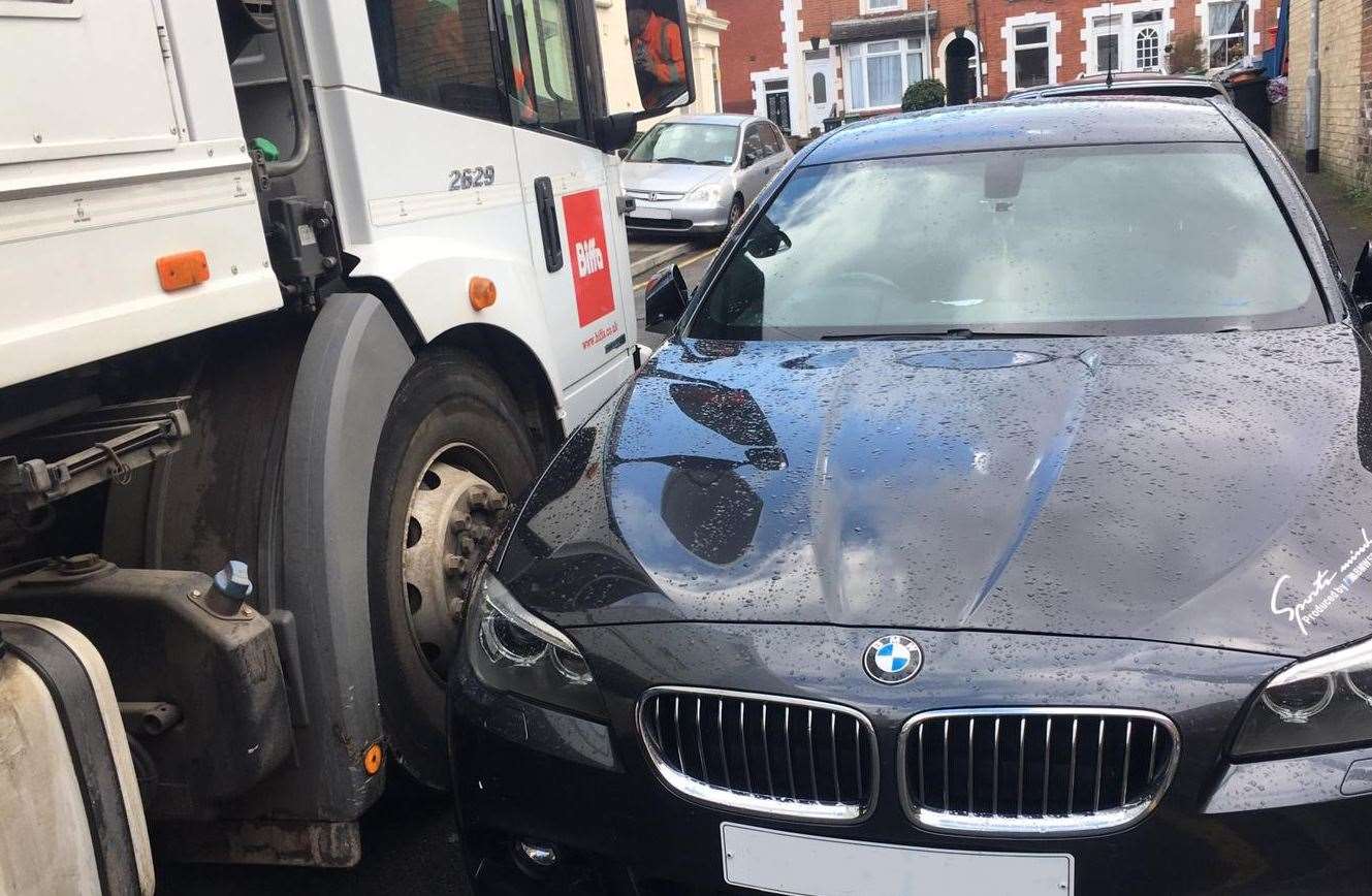 A refuse vehicle has trouble getting by because of parked cars Picture: MBC