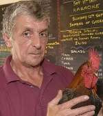 Peter Palmer, landlord of The Harp pub, with Corky. Picture: JOHN WARDLEY