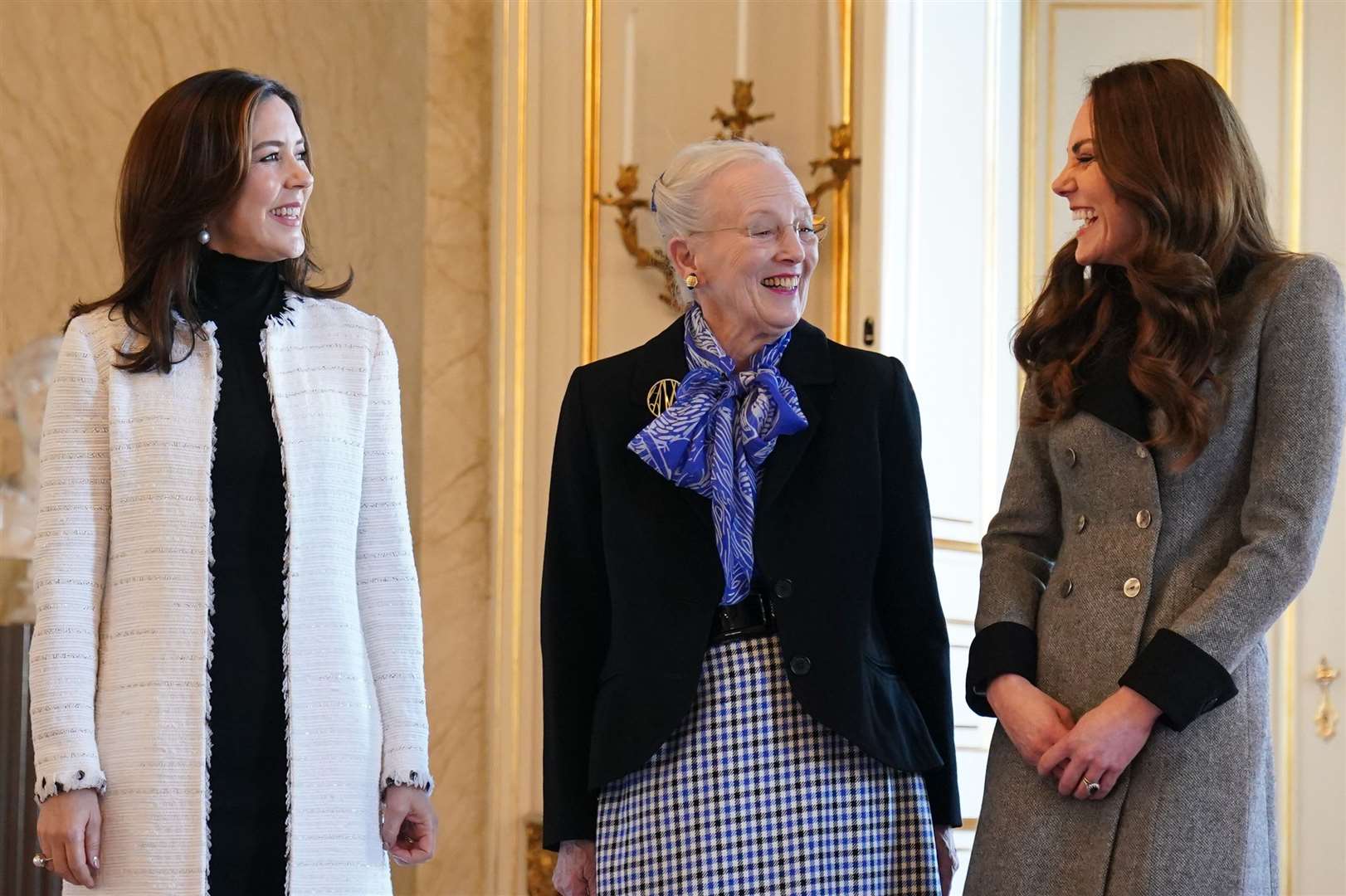 The Duchess of Cambridge is welcomed by Queen Margrethe II (centre) and Crown Princess Mary. Owen Humphreys/PA