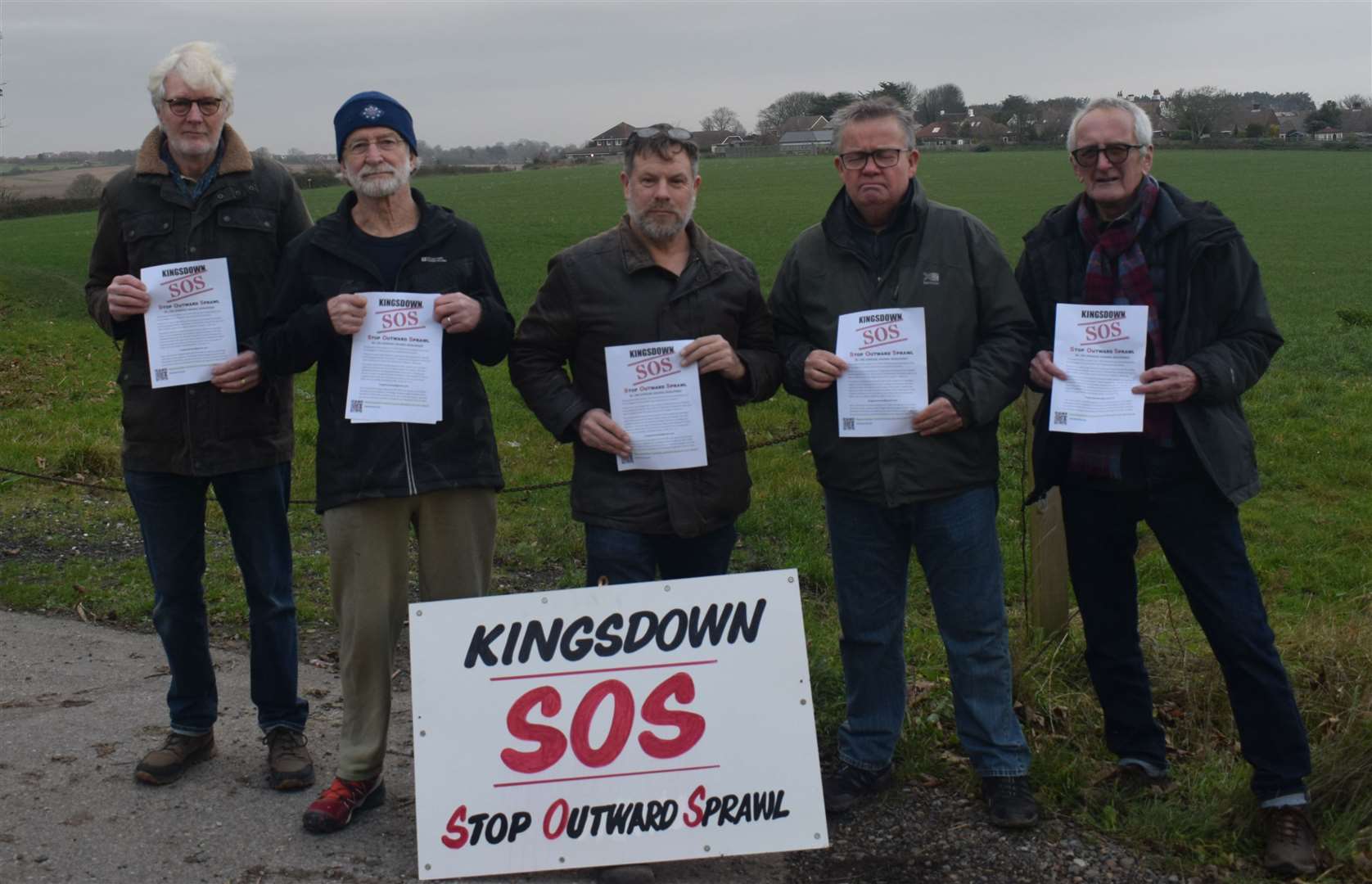 Members of Kingsdown SOS protesting against plans to build 70 homes on land directly behind them. The image includes leading members Jez Hermer, centre left, and Graeme Endacott, centre right