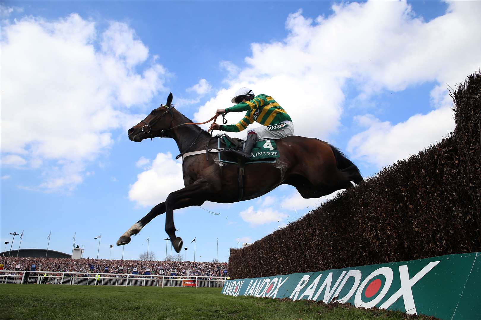 Jonbon ridden by jockey Aidan Coleman clear a fence on their way to winning the EFT Systems Maghull Novices’ Chase on day three of the Randox Grand National Festival at Aintree Racecourse (Nigel French for The Jockey Club/PA)