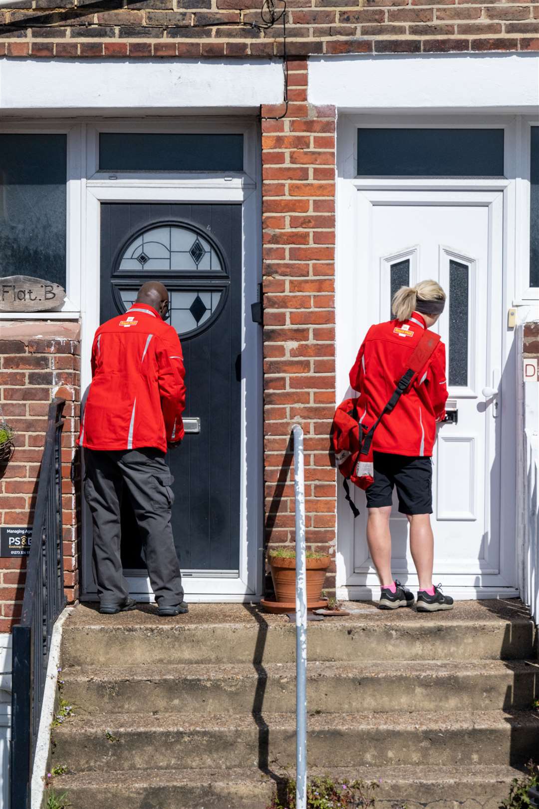 Postal workers Charles and Camilla deliver to a regal address – Coronation Street (Tony Kershaw/Royal Mail)