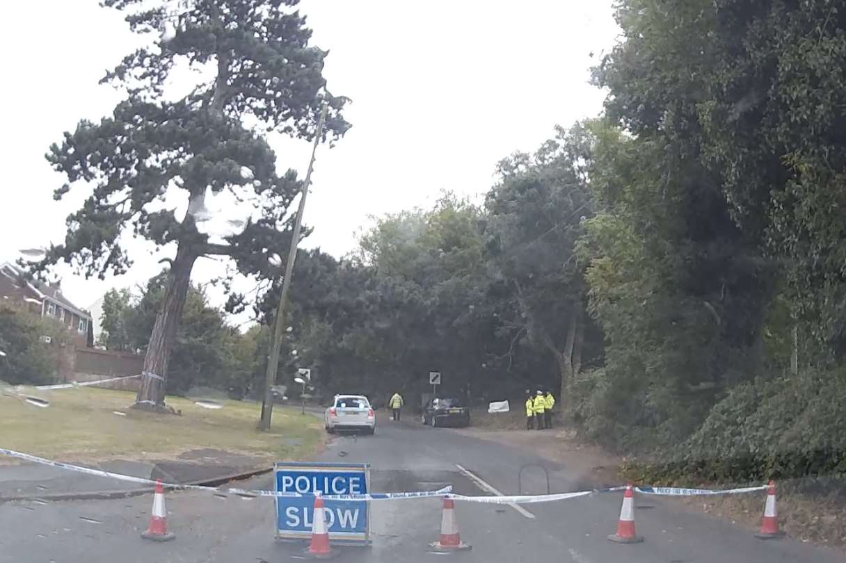 A police cordon has been set up after a car overturned