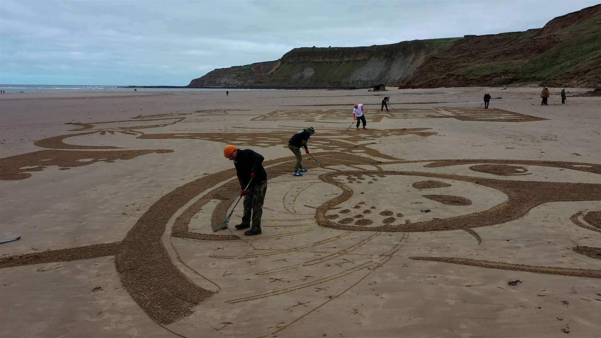 The sand drawing being created on Cayton Bay in Scarborough (Richard McCarthy/PA)