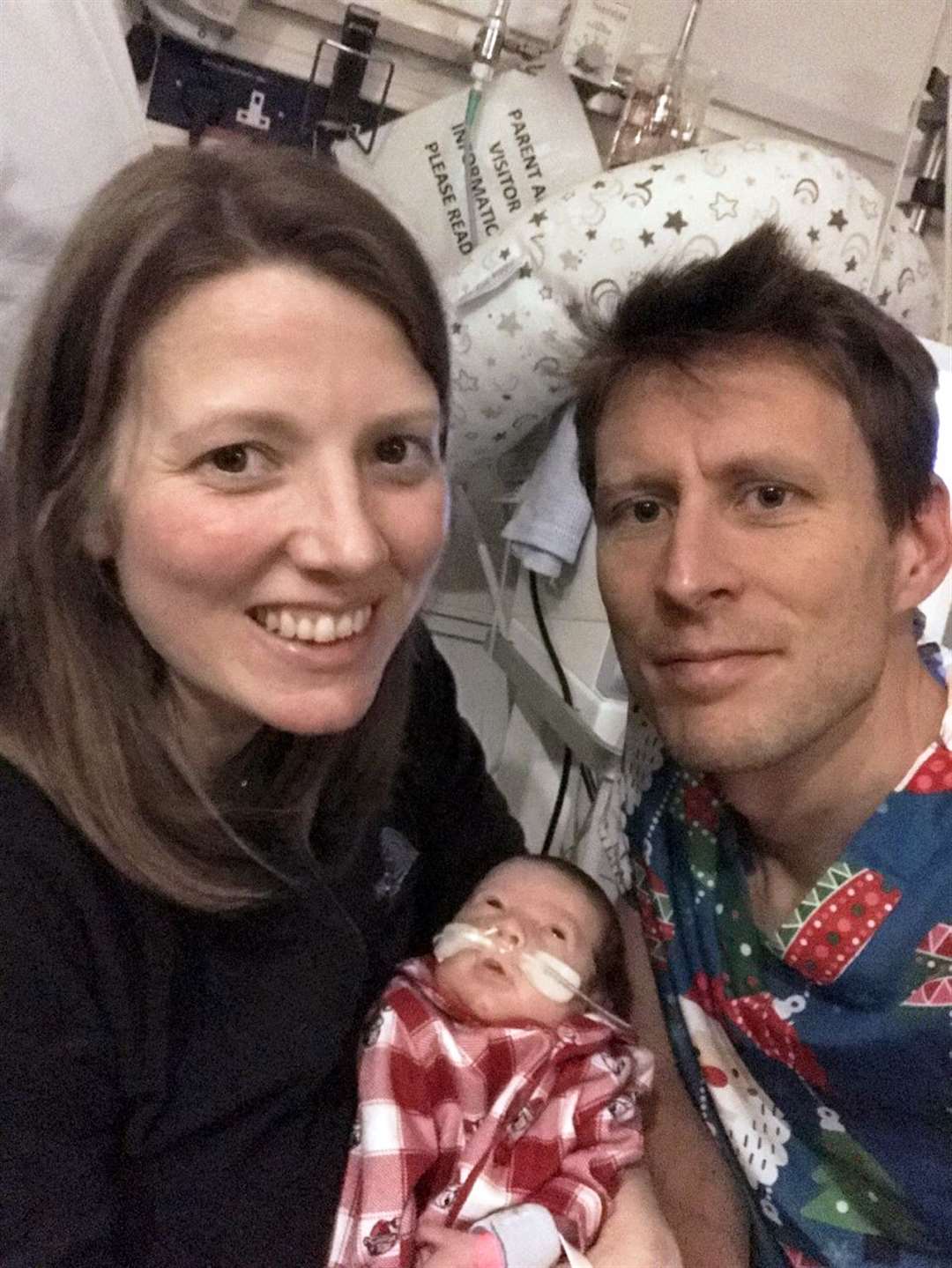 Parents Mikey and Bethany Bryant with son Finley in hospital at Christmas after he was born 11 weeks early (Swansea Bay UHB/Mikey Bryant/AP)