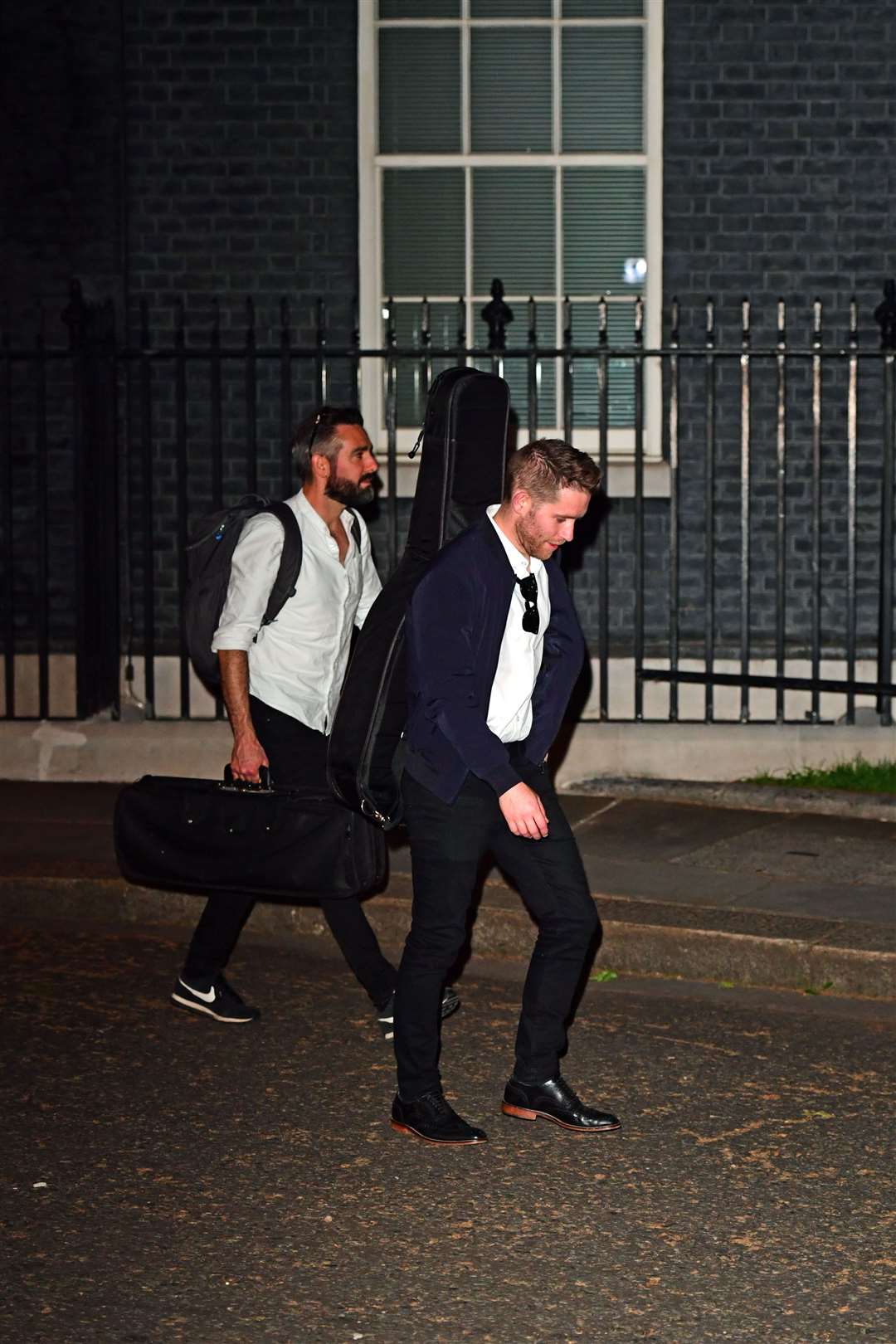 People carrying musical instruments leave 10 Downing Street on Saturday night (Ian West/PA)