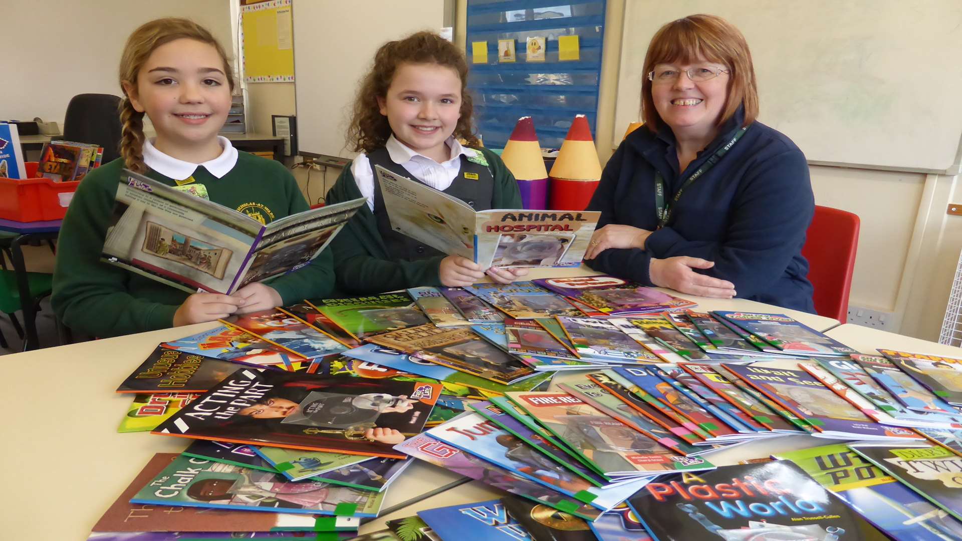 TA Susan Marren with Sophia Richardson, 11, and Eve Hollman, 10, of St Nicholas at Wade CE Primary School which won £250 for its library for being top for green travel in the county.