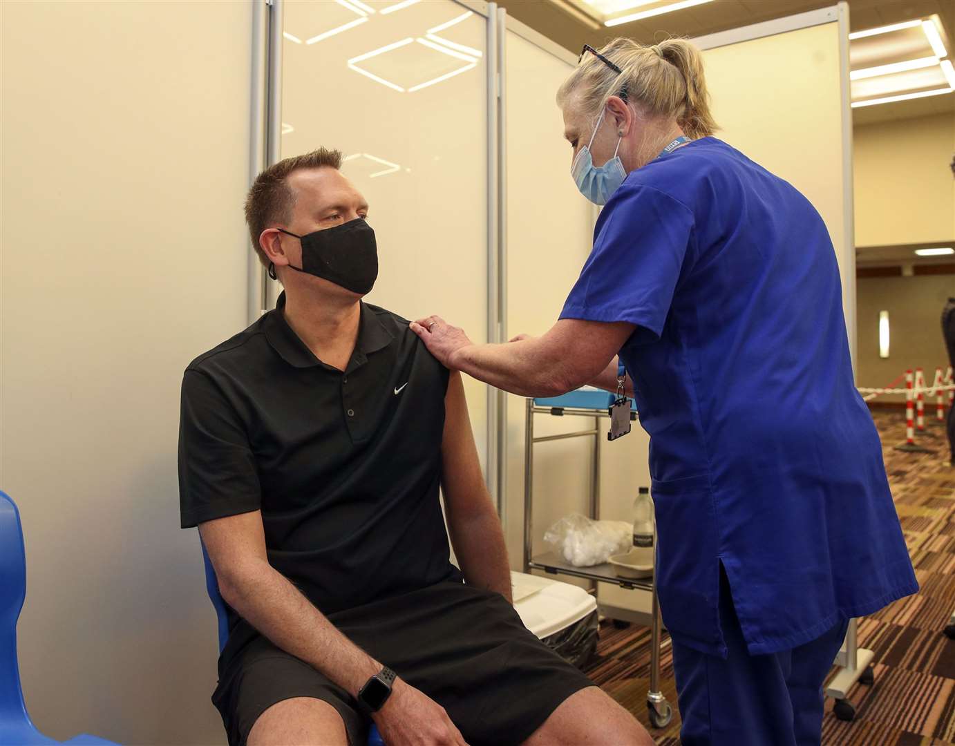 Martin Pluves from Wokingham receives an injection of the Moderna Covid-19 vaccine at the Madejski Stadium in Reading (PA)