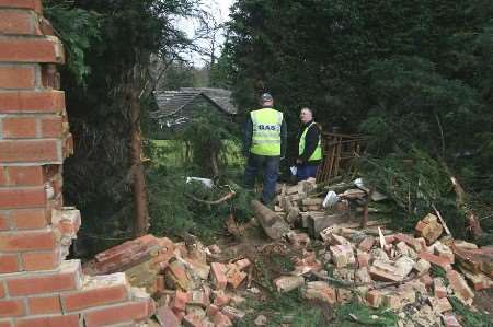 Gas engineers inspect the damage. Picture: JOHN WESTHROP