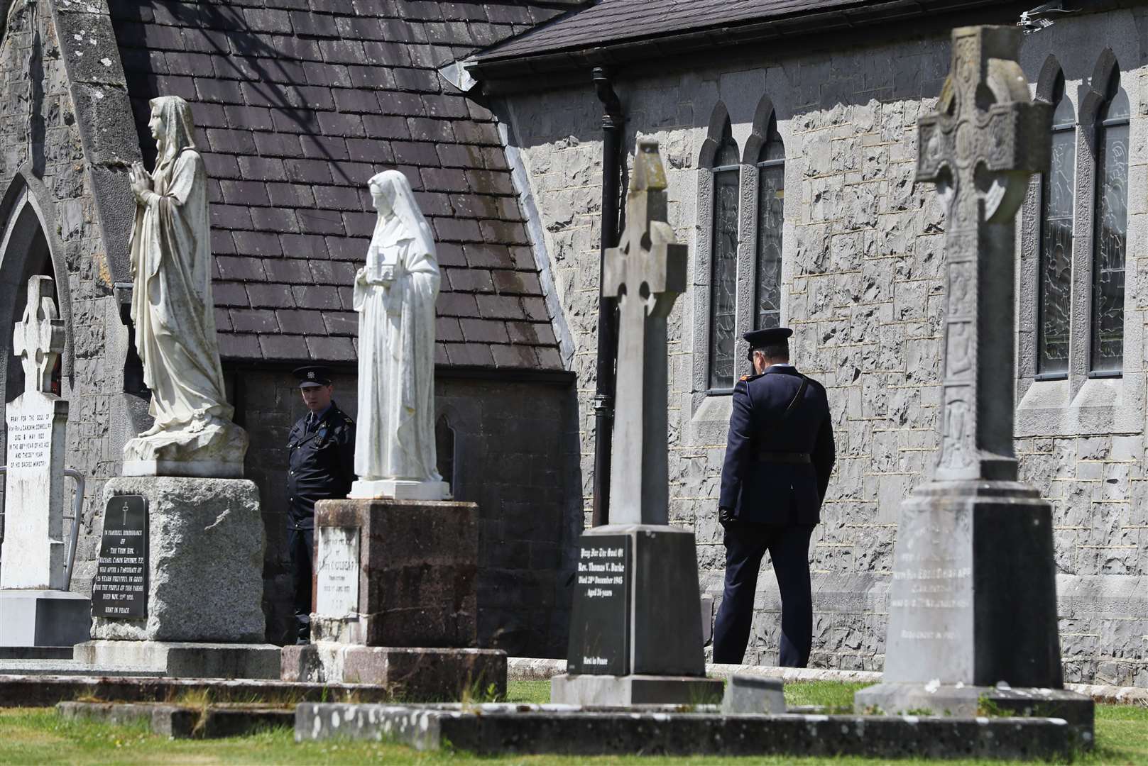 A member of the Garda outside St James’s church (Brian Lawless/PA)