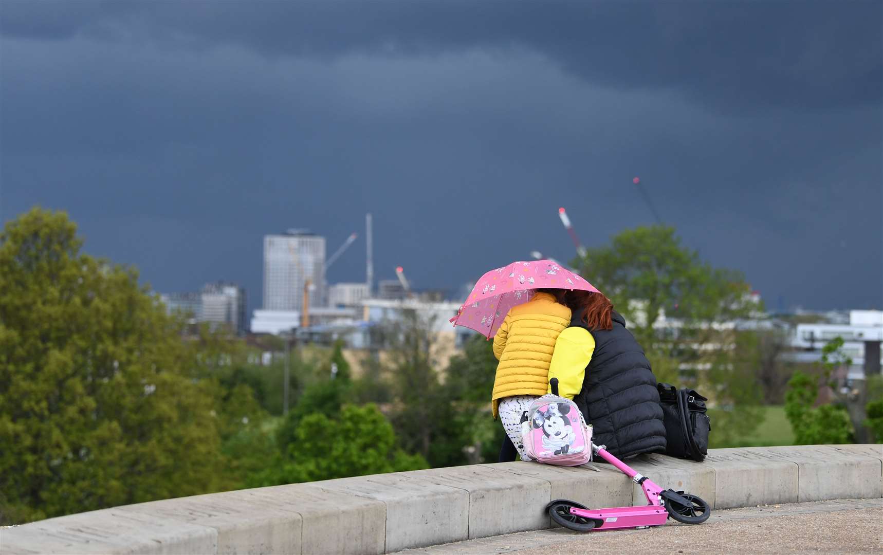 People looking at storm clouds over London from Primrose Hill (Stefan Rousseau/PA)