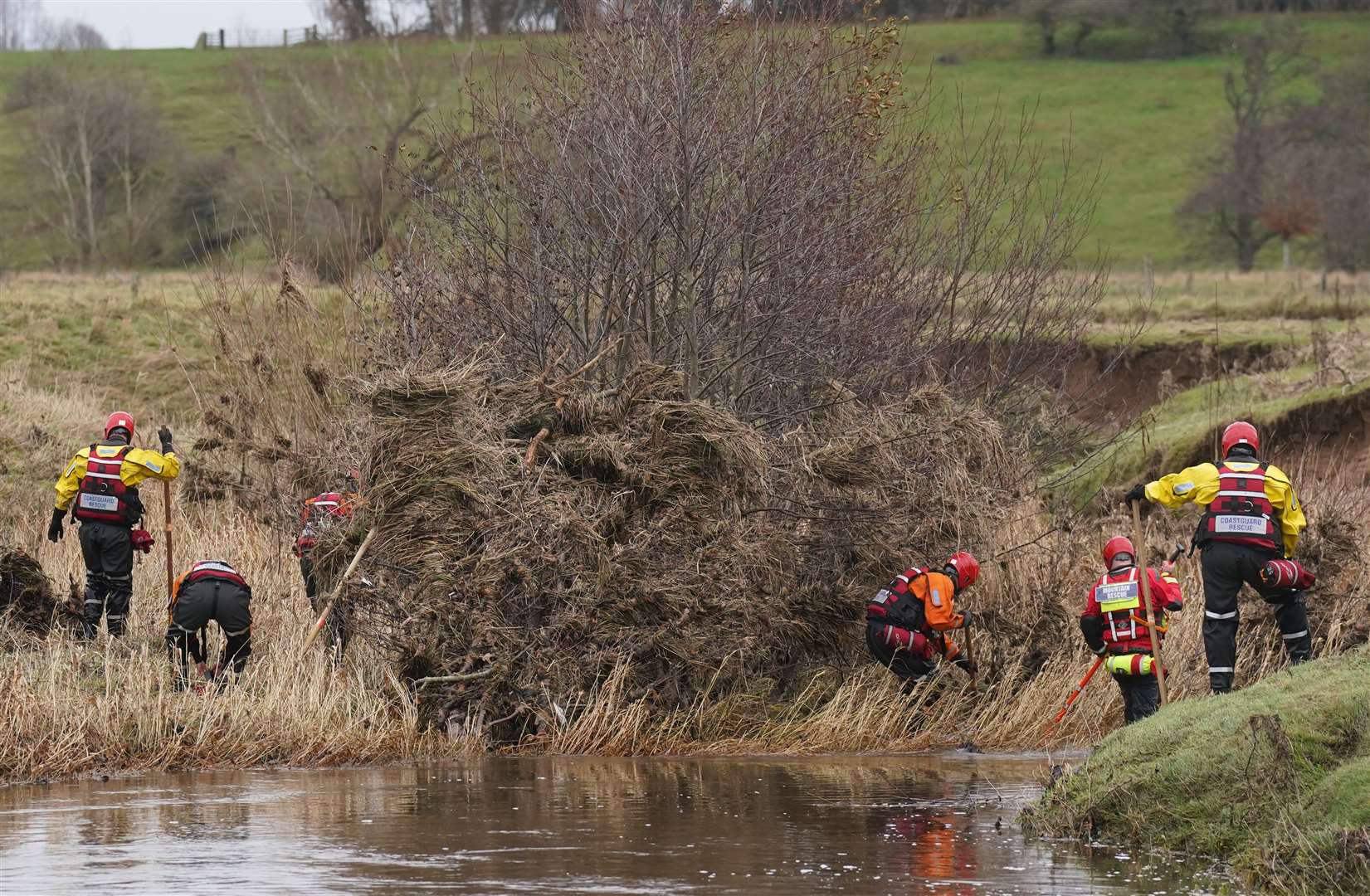 Members of a search and rescue team search through river debris during the operation at Abberwick Ford on the River Aln near Alnwick, Northumberland (Owen Humphreys/PA)