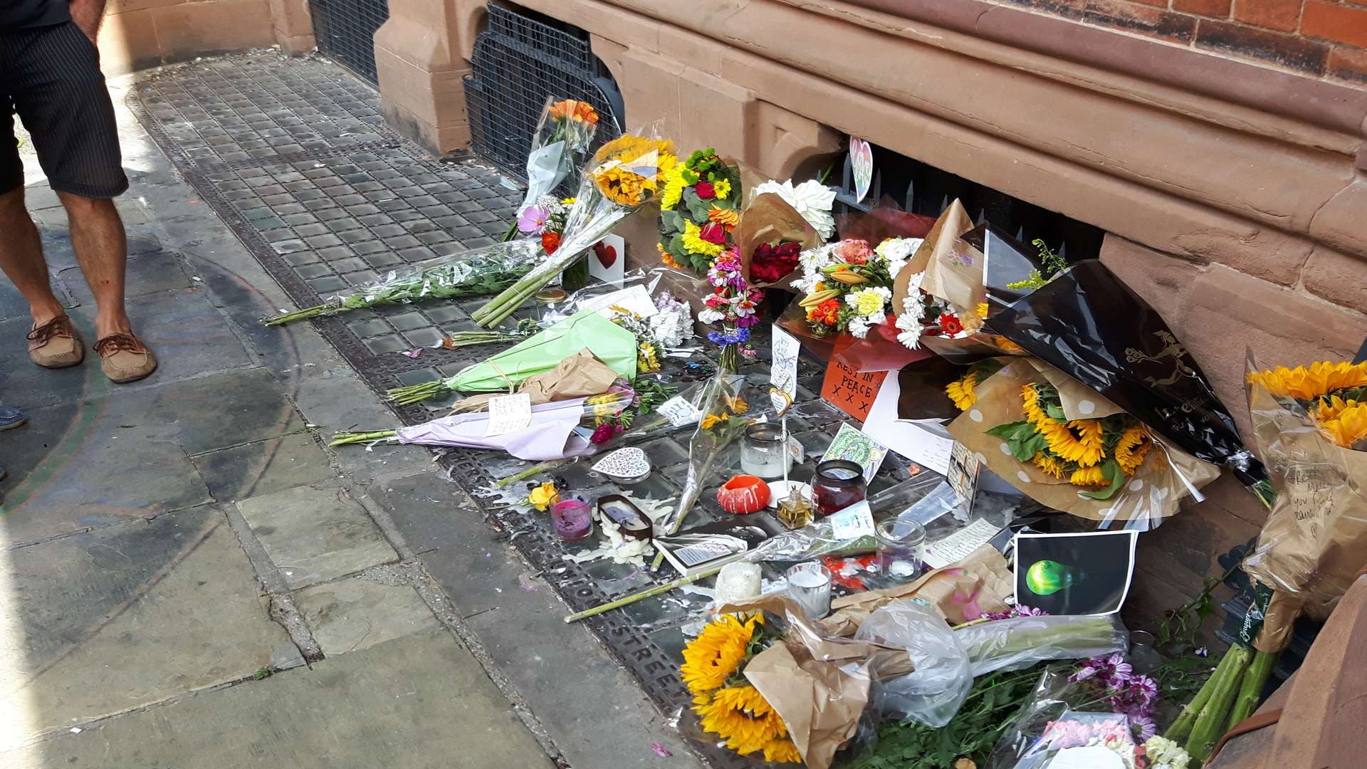Floral tributes to Maximum Martin, James Truscott and Joshua Lambert-Price outside the Beaney