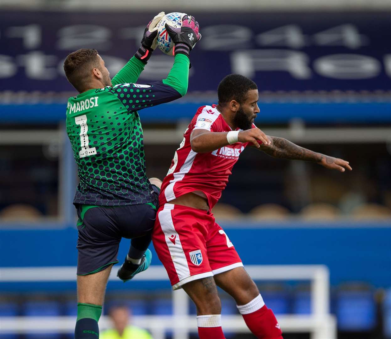 Gillingham forward Alex Jakubiak jumps with Coventry goalie Marko Marosi Picture: Ady Kerry