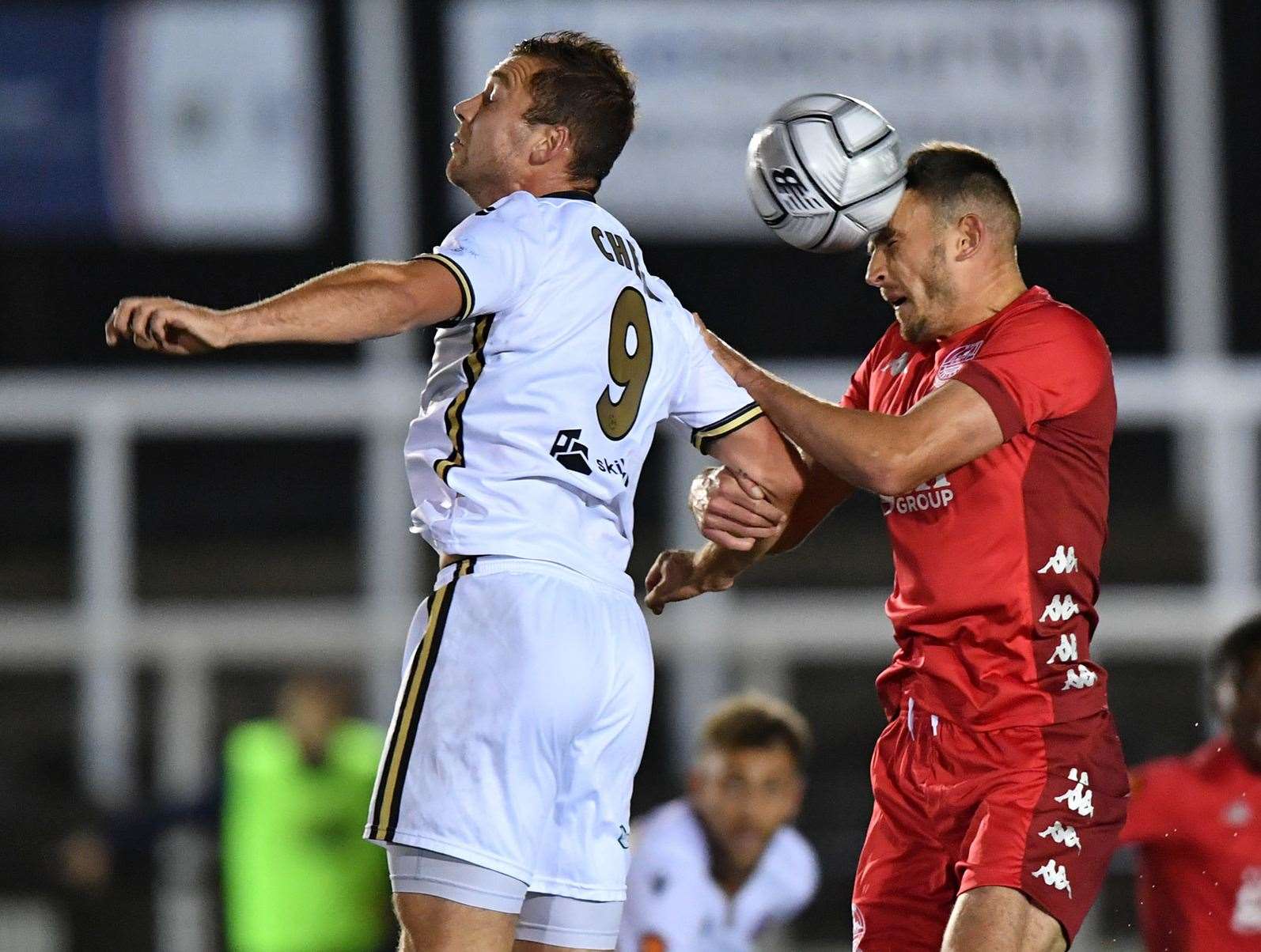 Dover's Will De Havilland jumps with Bromley forward Michael Cheek. Picture: Keith Gillard