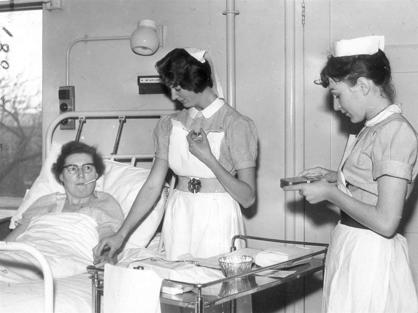 Nurses looking after a patient in Miriam women's surgical ward at All Saints' Hospital (Jan 1962)