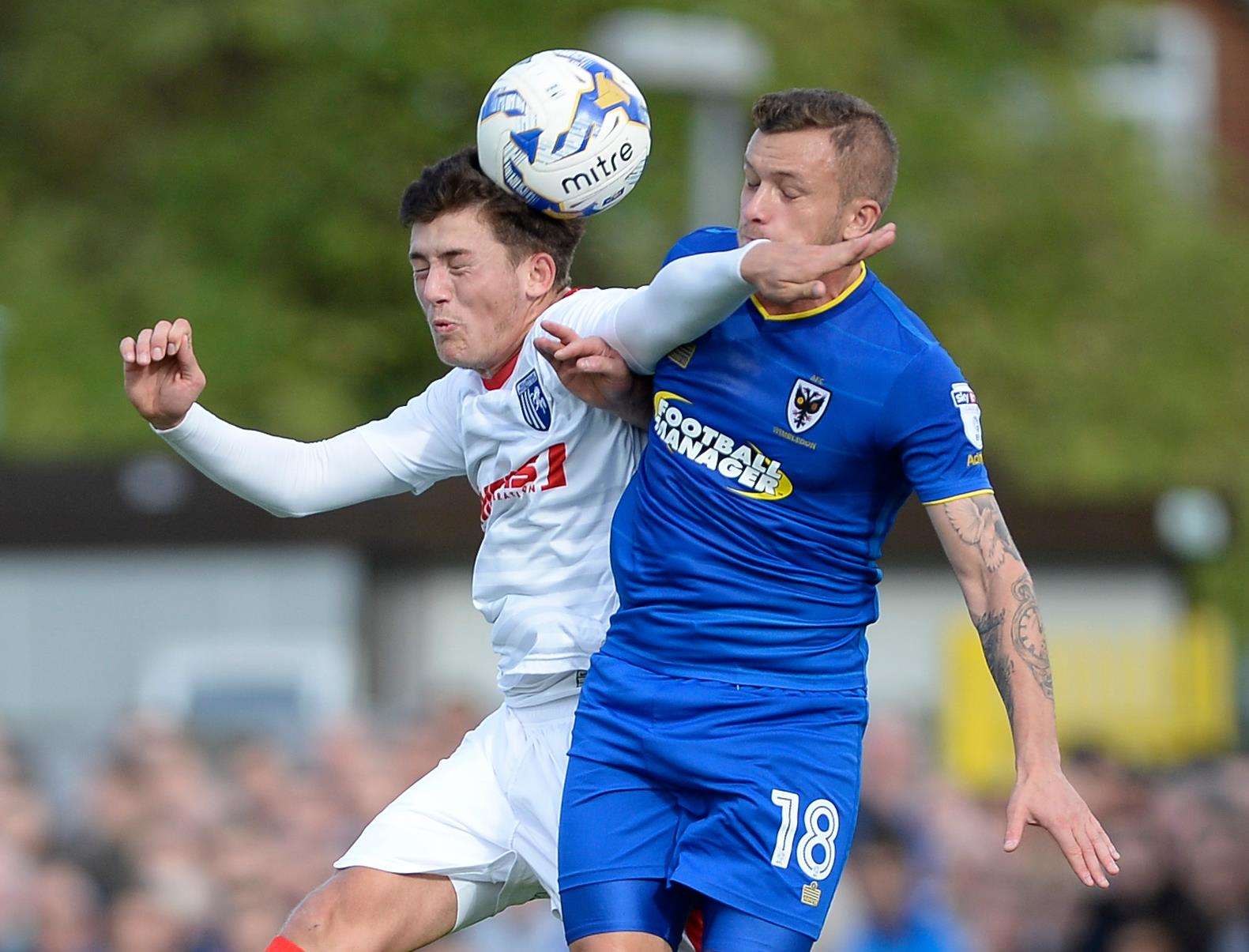 Darren Oldaker challenges Dean Parrett when the Gills played Wimbledon in October 2016