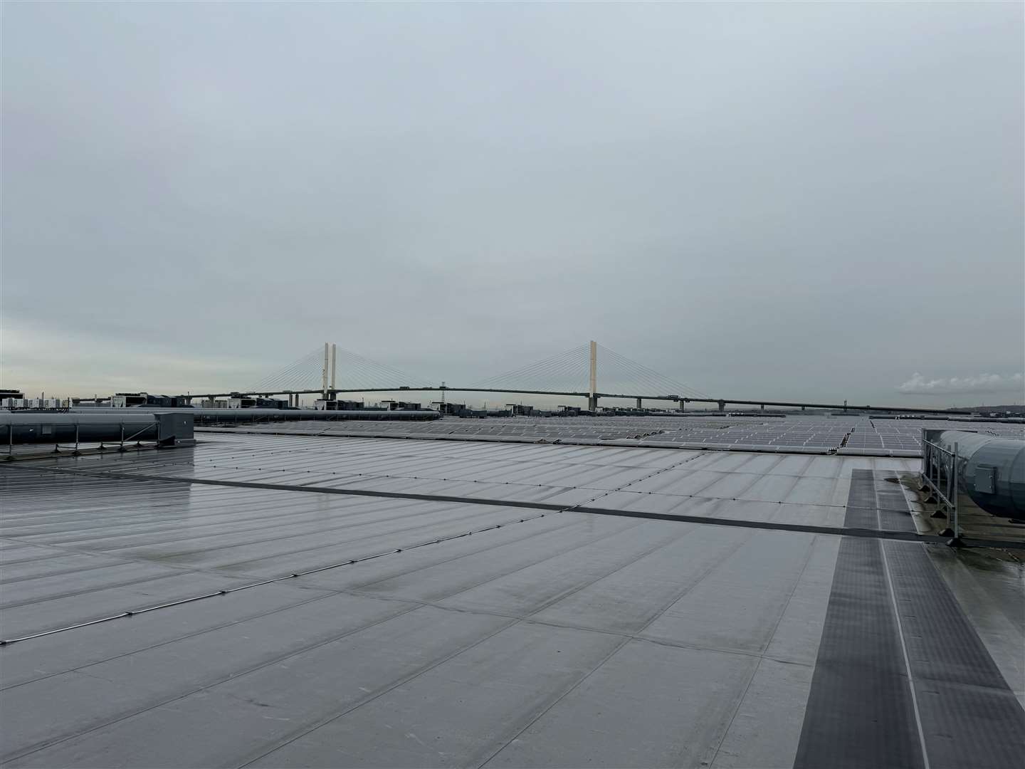 The 8,000 solar panels on the roof at the Amazon Dartford warehouse, with views of the Dartford Crossing