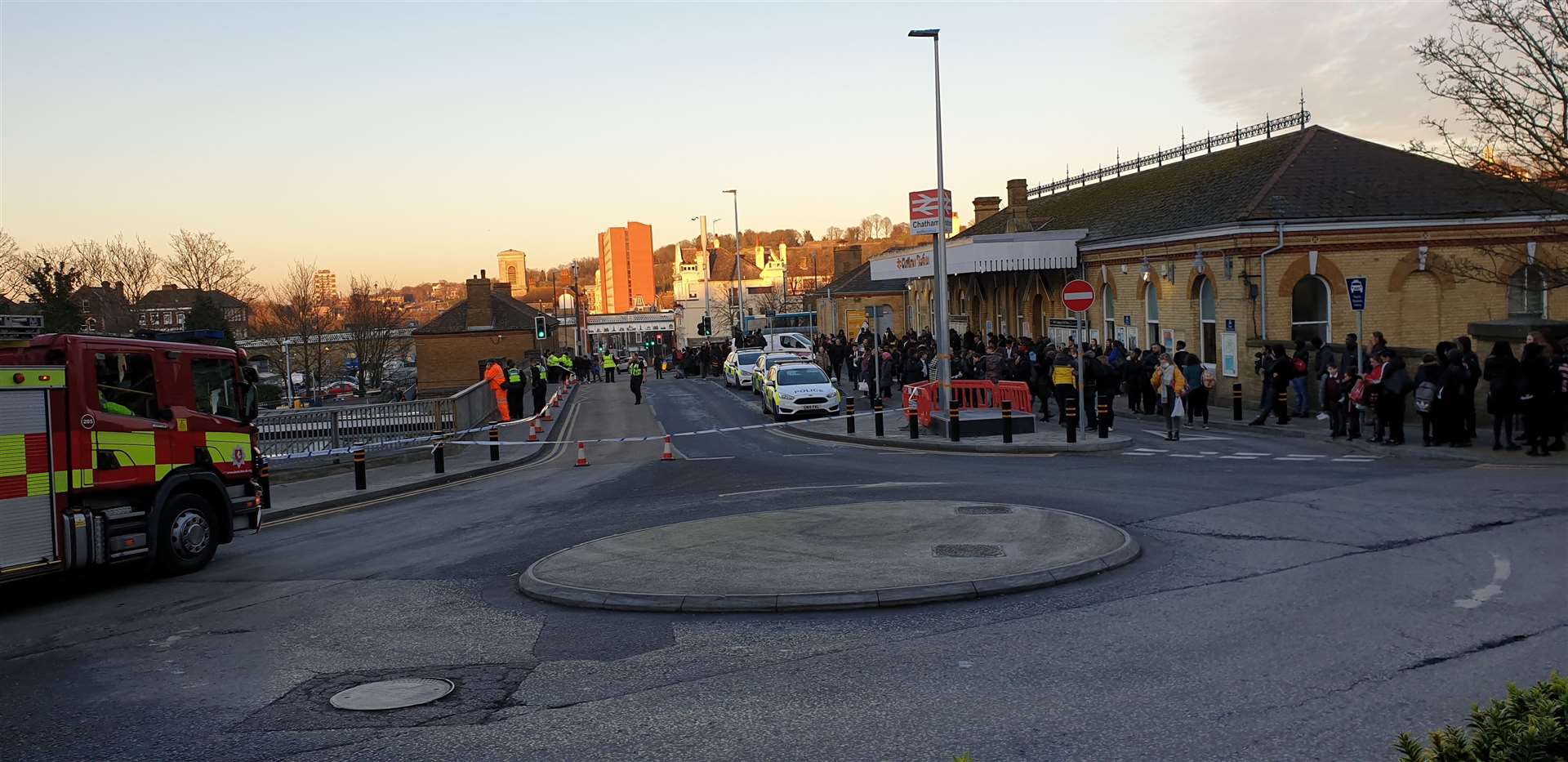 Hundreds of people can be seen outside Chatham Railway Station after a man was spotted on the bridge. Picture: Kim Young