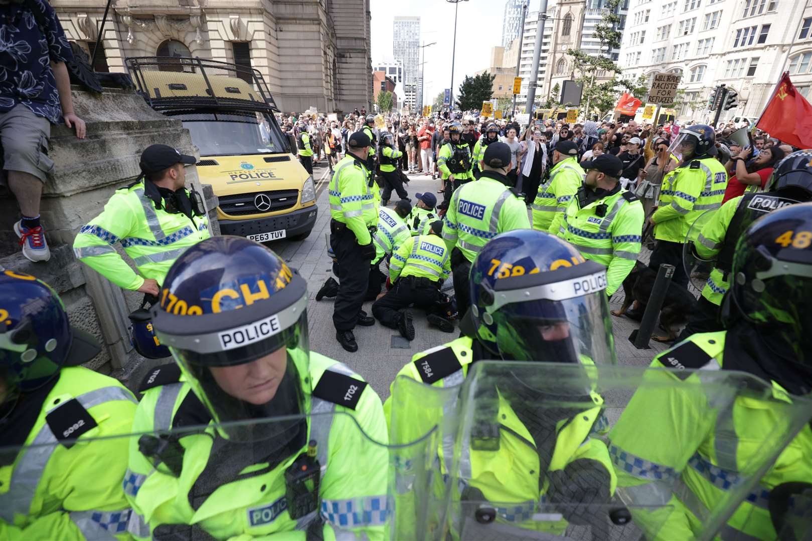 Police restrain a man during a protest in Liverpool (James Speakman/PA)