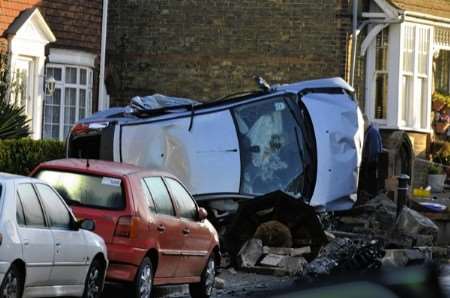 The scene of the accident at Teynham. The car struck the village memorial