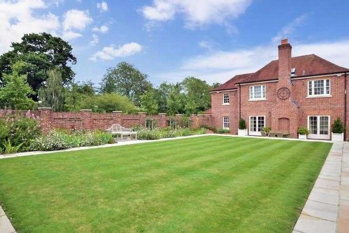 The neat lawn separates the main house from the annex. Picture: Fine and Country