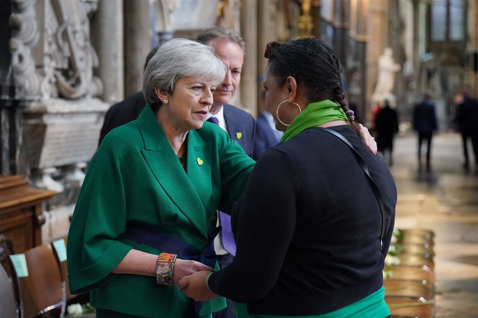 Theresa May, left, and community volunteer Claire Walker speak before the service (Jonathan Brady/PA)