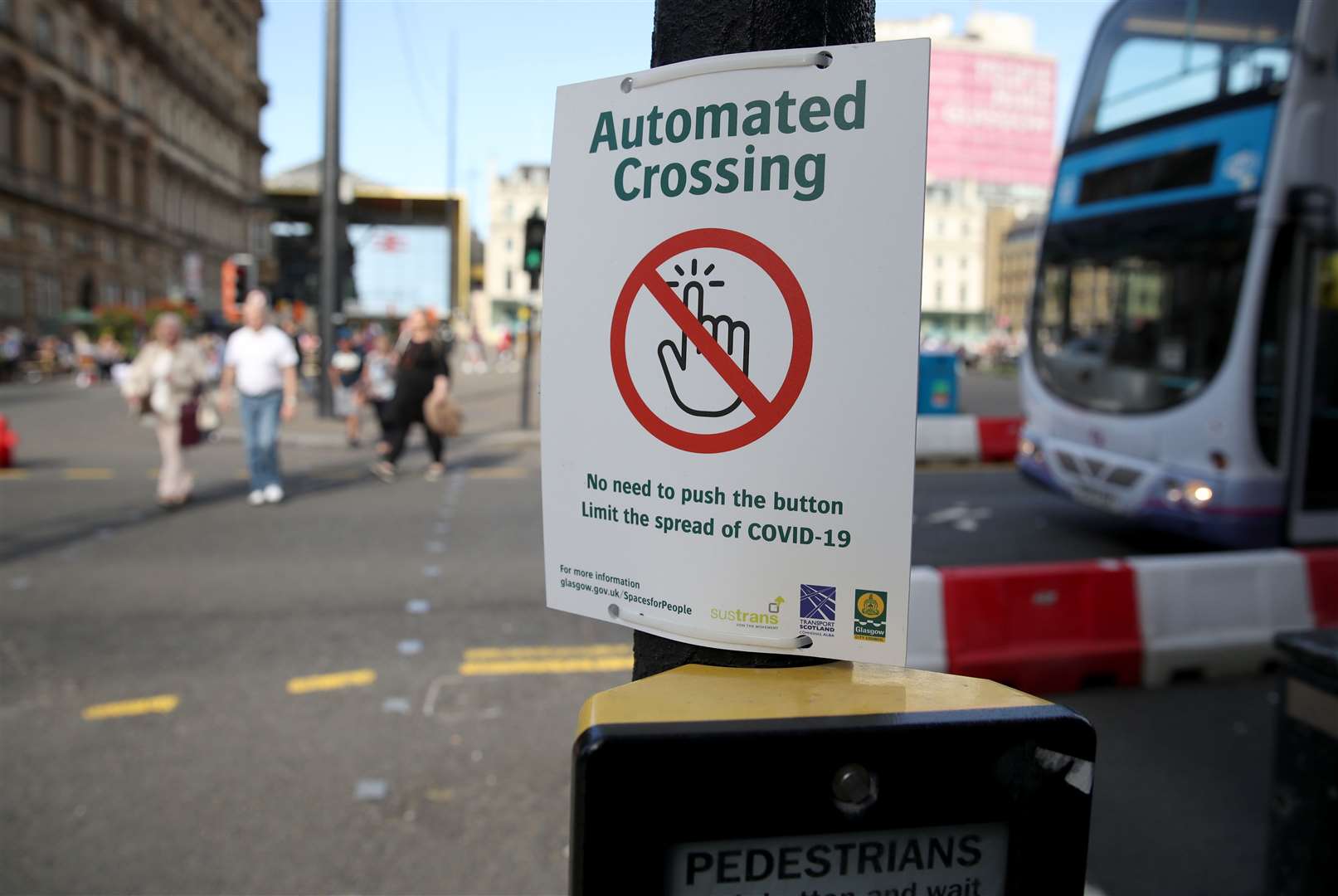 A sign at a crossing point in Glasgow city centre aims to help limit the spread of Covid-19 (Andrew Milligan/PA)