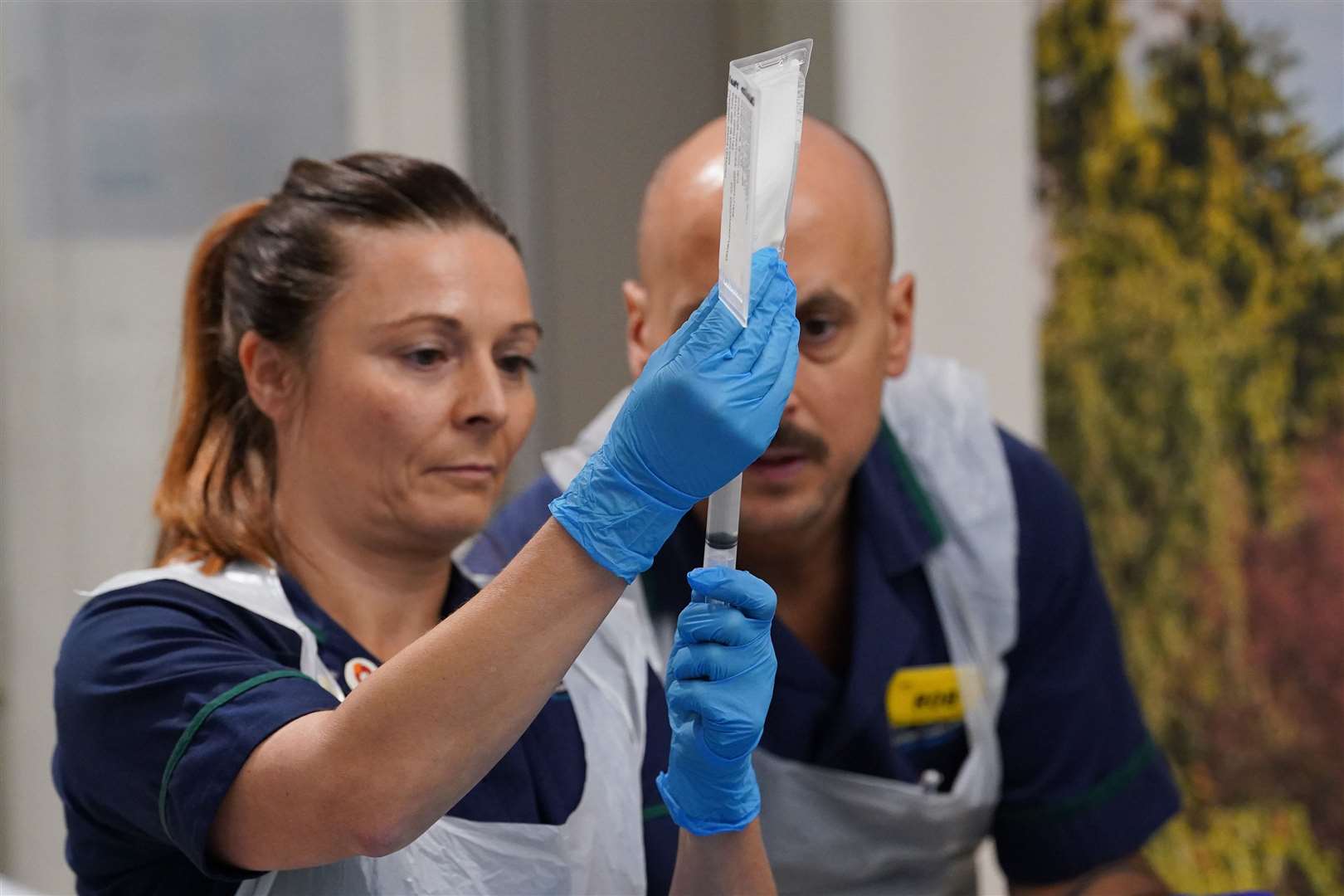 Senior clinical practice facilitators Nicole Prescott and Rob McDonnell prepare to administer a breakthrough CAR T infusion treatment for lupus to patient Katie Tinkler (Lucy North/PA)