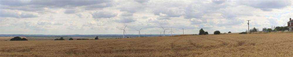 A draft artist impression of how the wind turbines could look, as viewed from the entrance to New Rides, from the south side of Eastchurch village