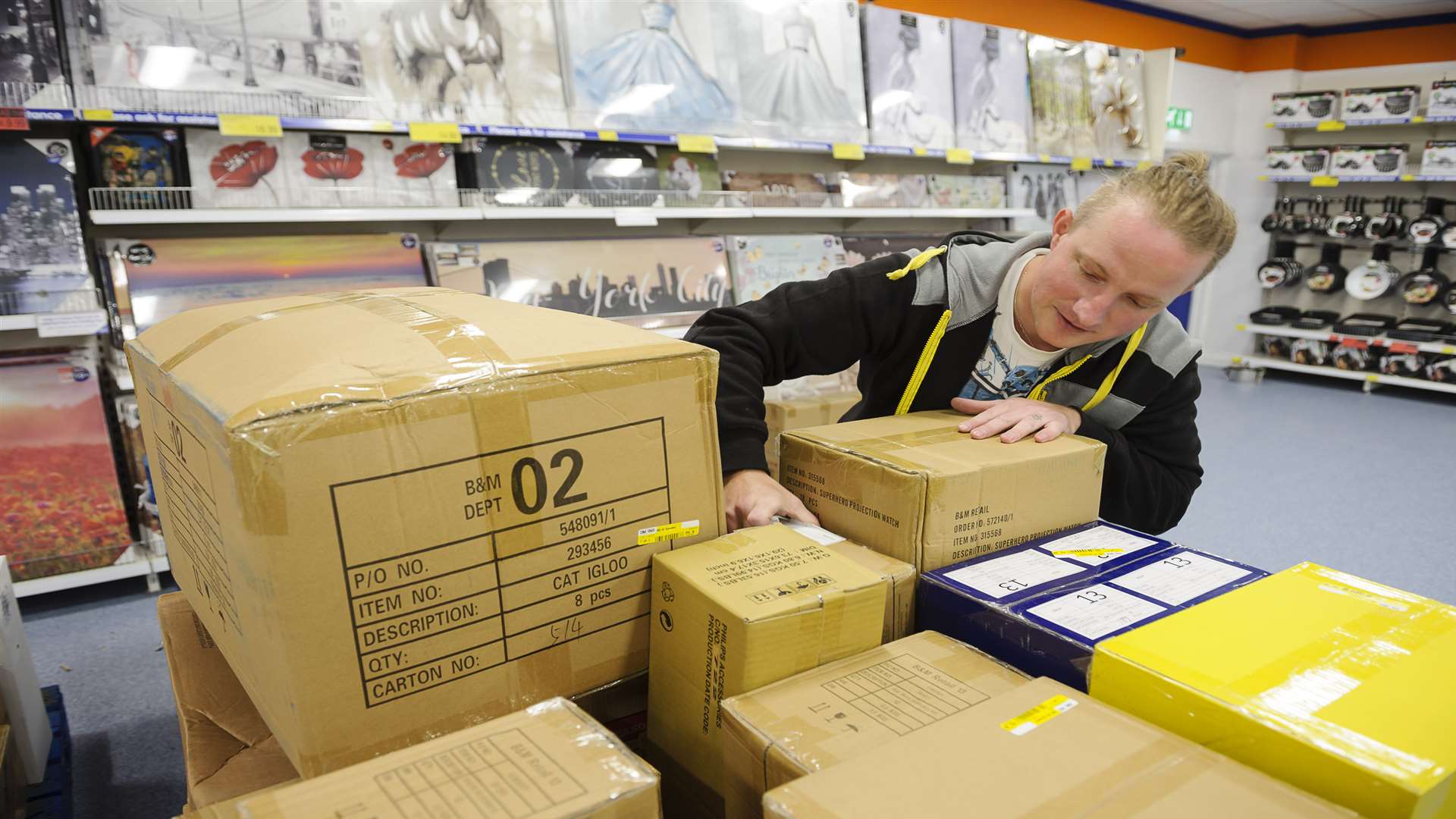 Gabriel Ipacs moving boxes out to the shop floor.