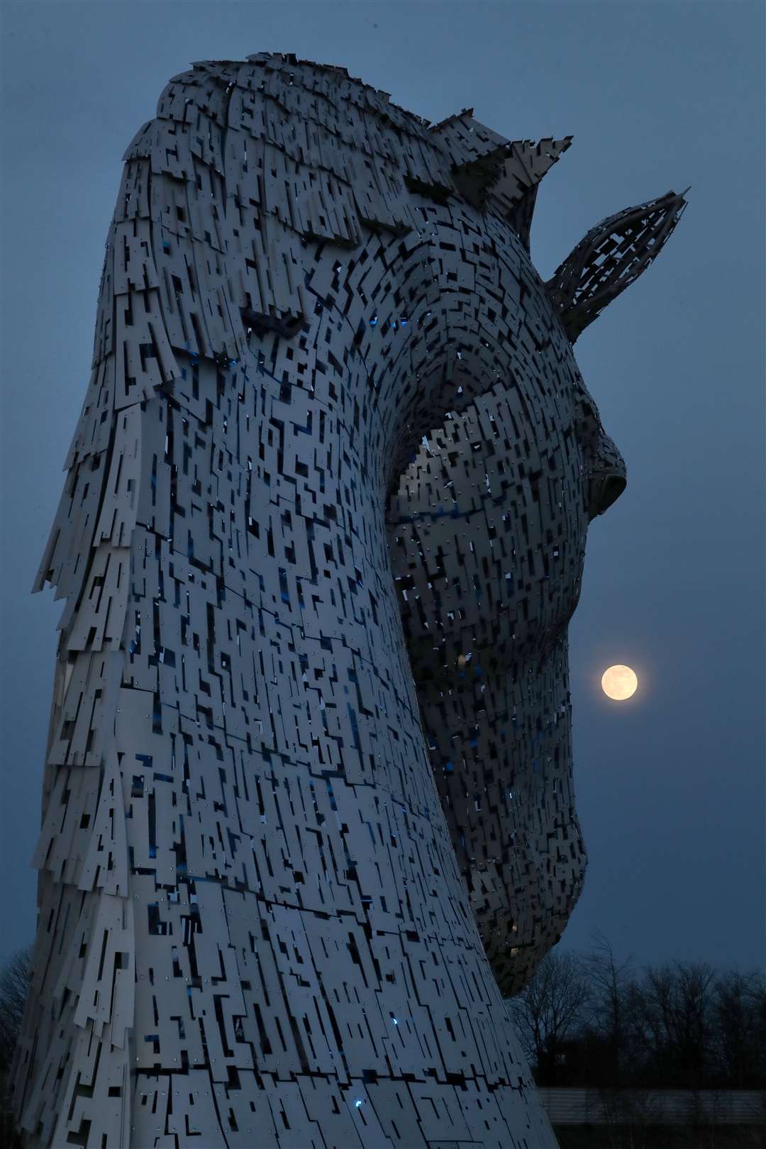 A pink supermoon is seen over the Kelpies sculpture in Falkirk (Andrew Milligan/PA)