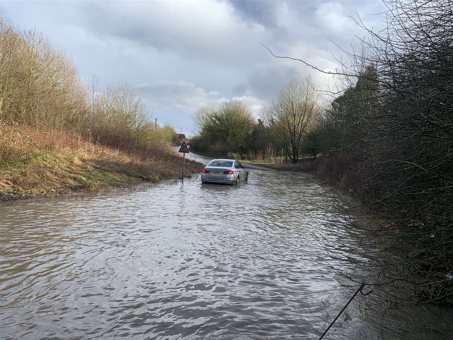 The car became stuck after trying to drive through the flooding