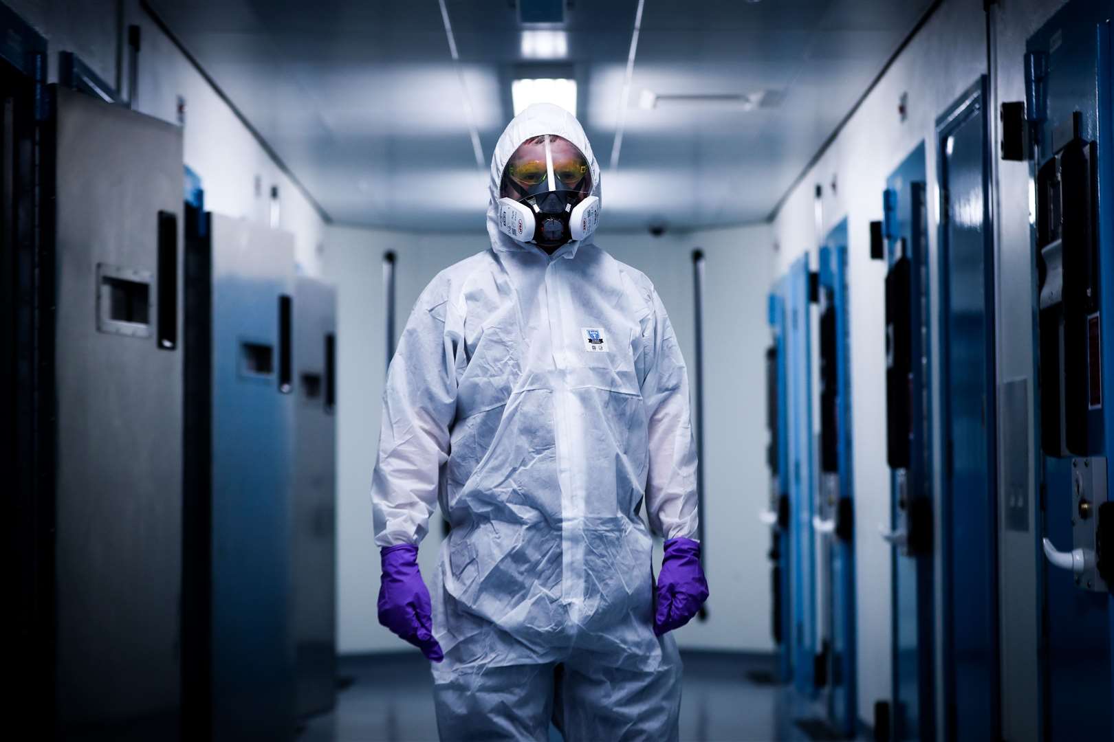 A member of the PSNI Musgrave Street custody team wearing the PPE required to interact with a detained person suspected of having Covid-19 in Belfast (Niall Carson/PA)