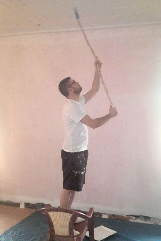 Lee Adkin tackles the painting of a ceiling in the school's dining hall.