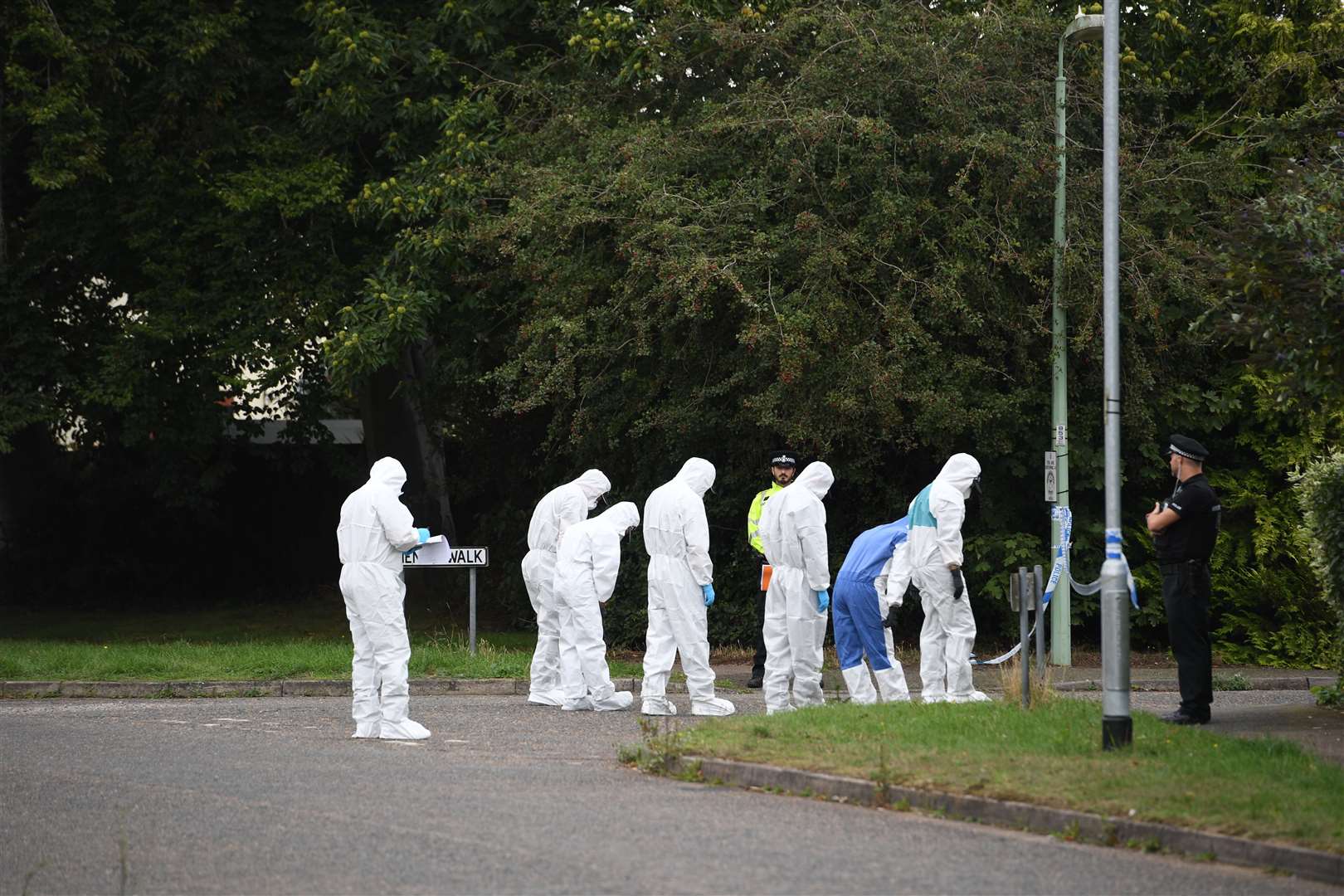 Police officers carry out a search in Friends Walk, Kesgrave, Suffolk, where a 15-year-old student was shot on his way to school (Joe Giddens/PA)