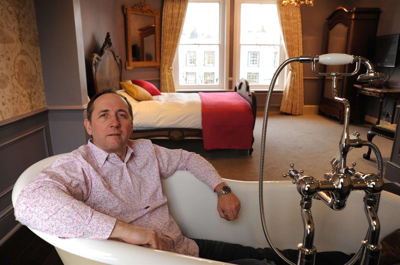 Julian Leefe-Griffiths, owner of The Tunbridge Wells Hotel and Restaurant, located in The Pantiles, inside the bathtub within one of his hotel rooms